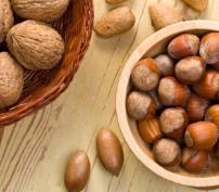 A woven basket filled with whole walnuts