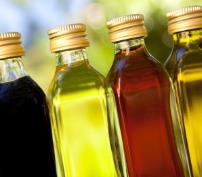Four glass bottles filled with different oils