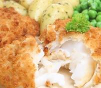 Crispy breaded fish fillet served with boiled potatoes and green peas